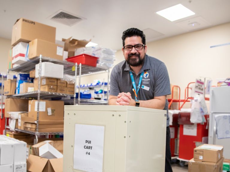 A man standing in a supply room