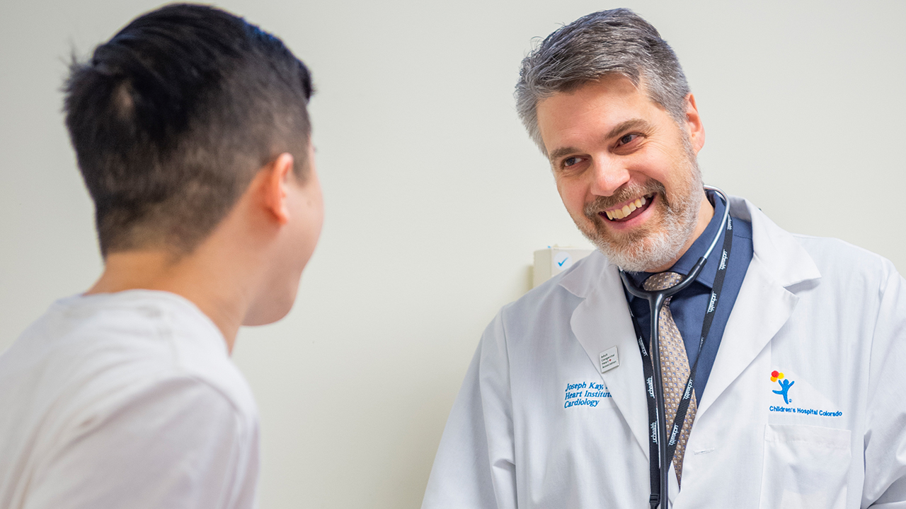 Provider and patient smiling and talking with each other.