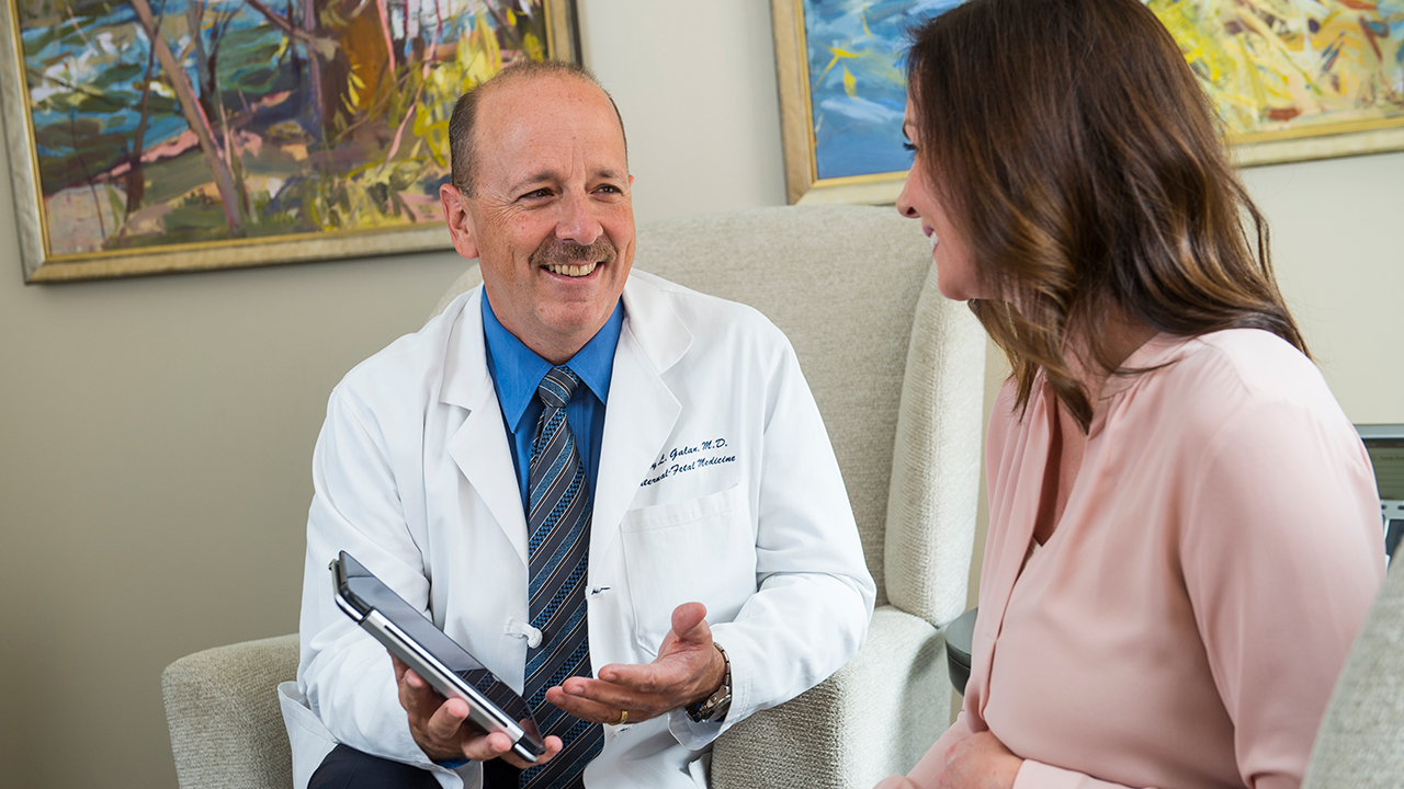 Dr. Galan talks with a woman in the maternal fetal program.