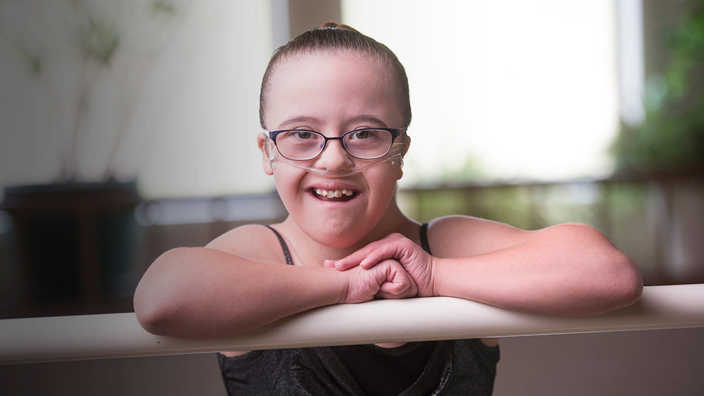 Kylie standing at ballet barre. Because she couldn’t tolerate a CPAP mask, Kylie Tatro’s nighttime oxygen concentrations were dangerously low, which was making her pulmonary hypertension worse. These days, she’s dancing ballet.